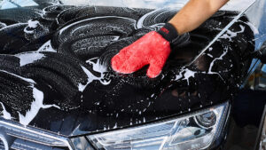 Lavage carroserie voiture noir avec gants Sonax